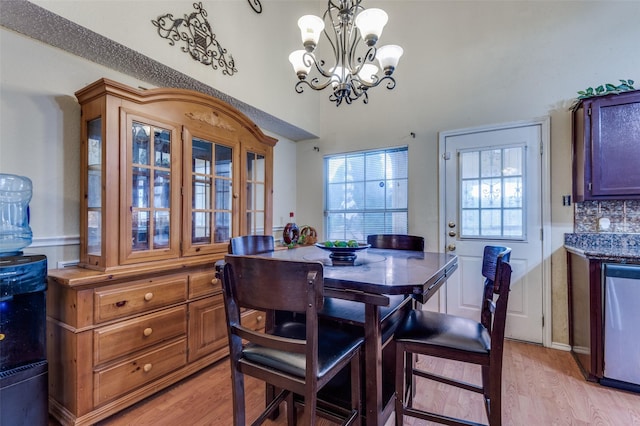 dining space with light wood-style flooring and a chandelier