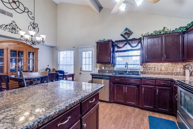 kitchen featuring tile countertops, light wood finished floors, stainless steel appliances, visible vents, and a sink