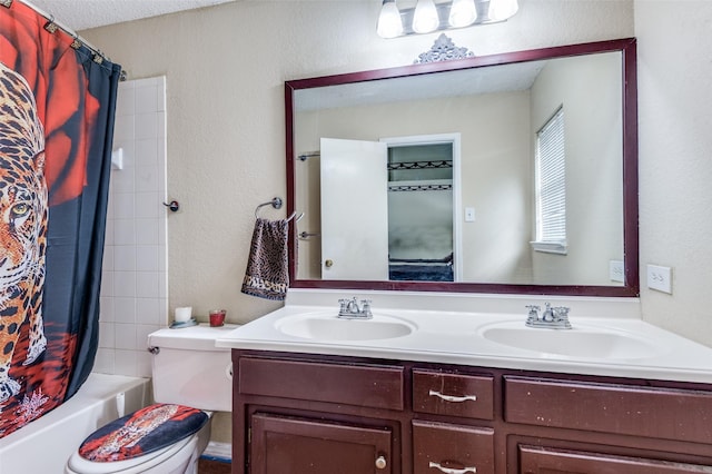 full bath with toilet, double vanity, a sink, and shower / bath combo with shower curtain