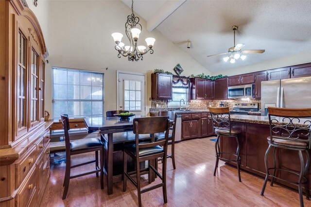 dining room featuring light wood-type flooring, high vaulted ceiling, beam ceiling, and ceiling fan with notable chandelier