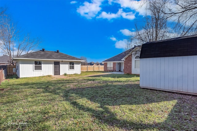 view of yard with a fenced backyard and an outbuilding