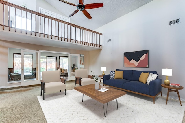 living room featuring a ceiling fan, baseboards, visible vents, and carpet flooring