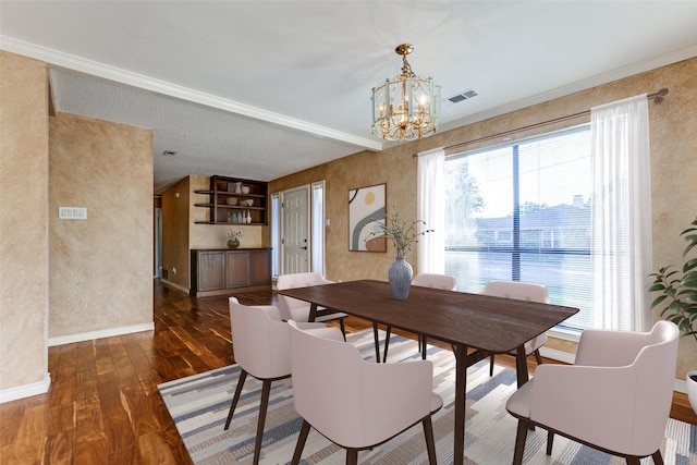 dining area featuring baseboards, hardwood / wood-style floors, visible vents, and a notable chandelier