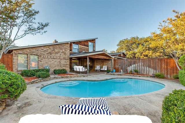 view of swimming pool featuring a patio area, fence, and a fenced in pool