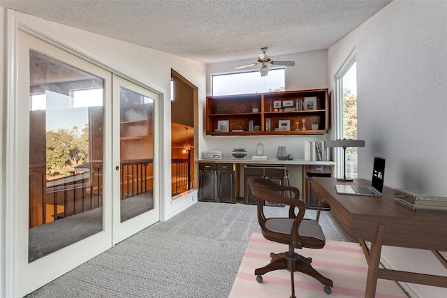 office area with a textured ceiling, a ceiling fan, french doors, and light colored carpet