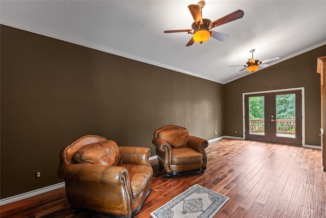 living area featuring french doors, crown molding, lofted ceiling, wood finished floors, and baseboards