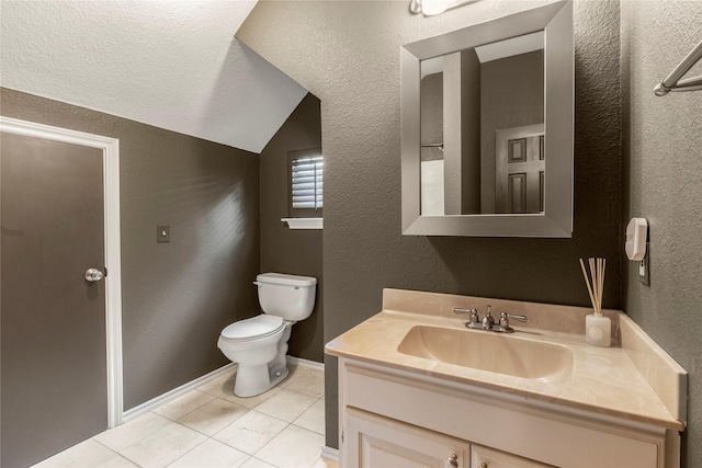 bathroom featuring baseboards, a textured wall, toilet, lofted ceiling, and vanity