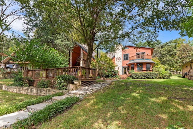 view of yard featuring a deck and a balcony