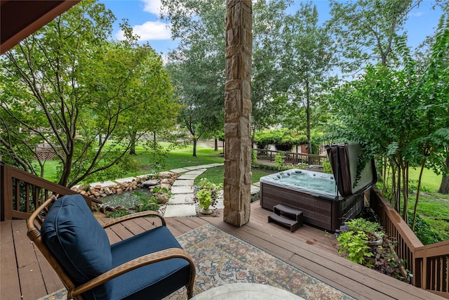 deck featuring a hot tub and a yard