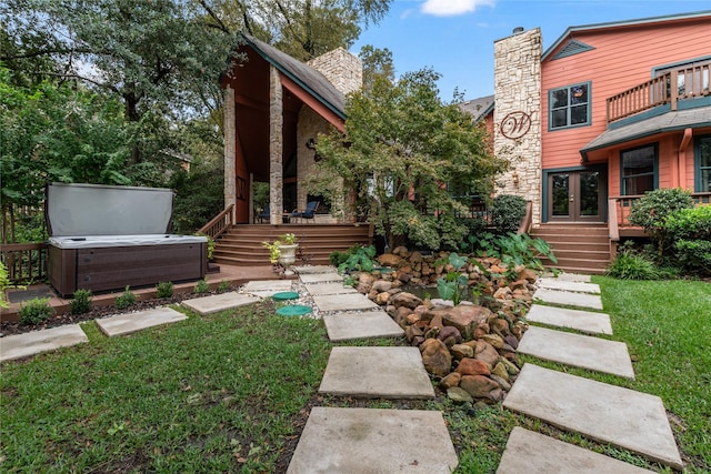 view of yard featuring french doors and a hot tub