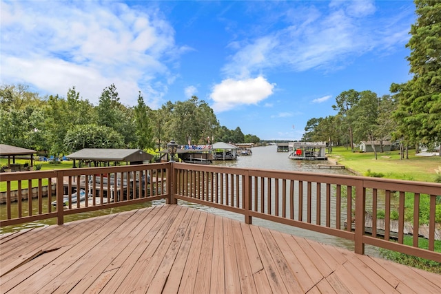 wooden terrace with a boat dock and a water view