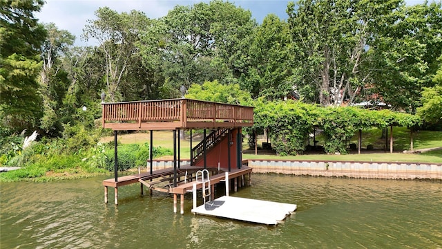 dock area with stairway and a water view