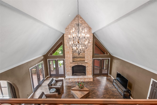 living room with a stone fireplace, french doors, and high vaulted ceiling