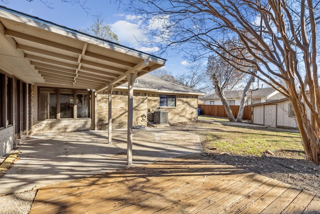 wooden terrace featuring central AC, a patio, and fence