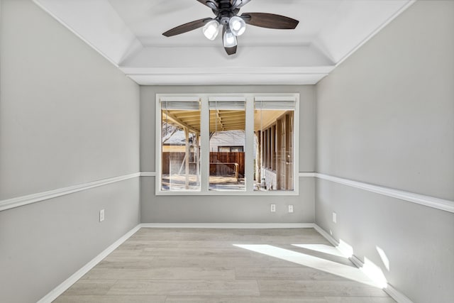 empty room with a ceiling fan, baseboards, and wood finished floors