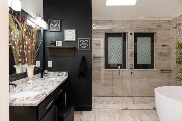 bathroom with a freestanding tub, a sink, a shower stall, and double vanity