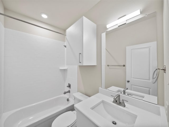 bathroom with washtub / shower combination, vanity, and toilet