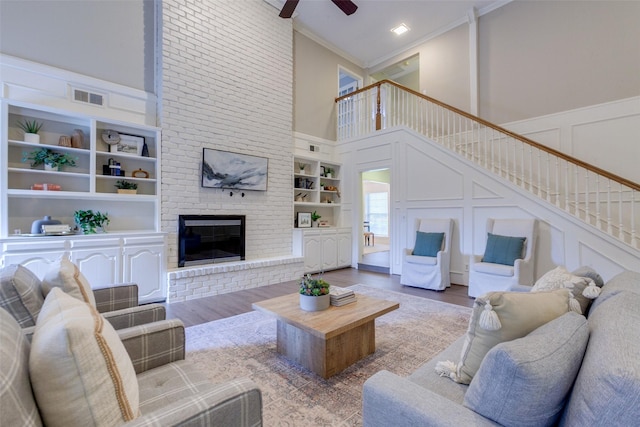 13 Gettysburg Ln, Richardson, TX 75080 - living room with a decorative wall, ornamental molding, a towering ceiling, stairs, and built in shelves