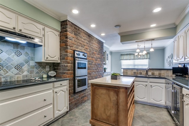 kitchen featuring black electric stovetop, stainless steel double oven, under cabinet range hood, a sink, and a center island