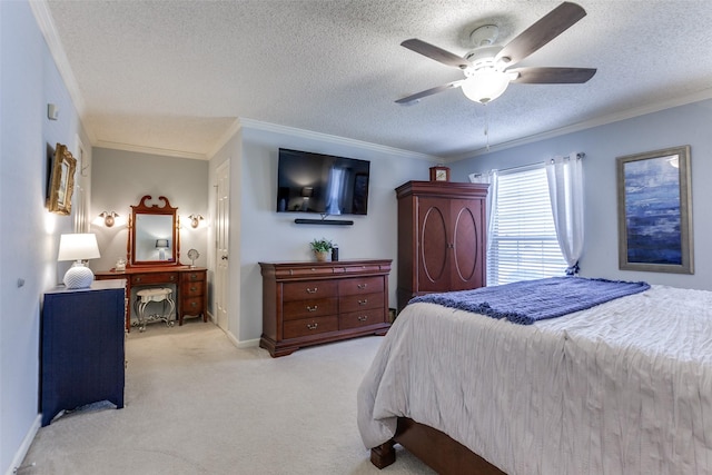 bedroom with carpet flooring, a textured ceiling, ornamental molding, a ceiling fan, and baseboards