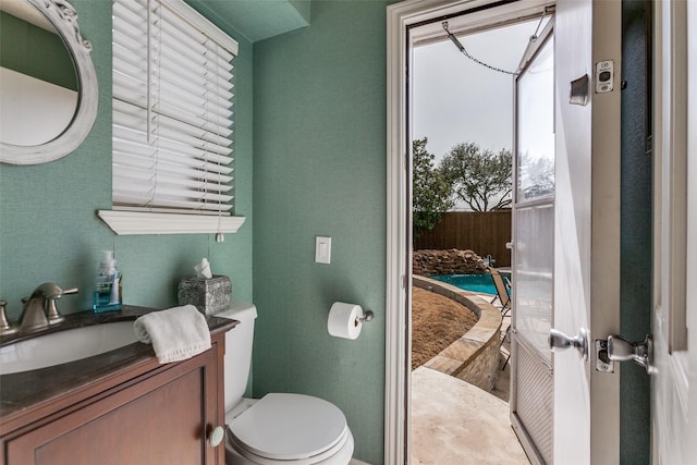 bathroom featuring toilet and vanity