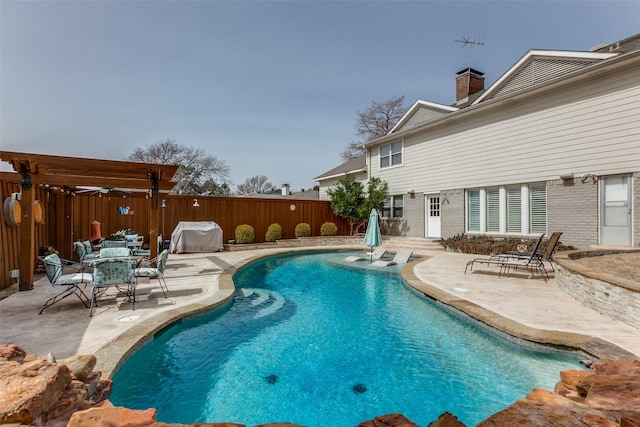 view of pool featuring a patio area, fence, a fenced in pool, and a grill