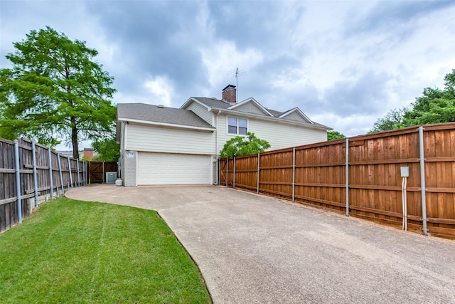 view of side of home featuring driveway, brick siding, and a garage
