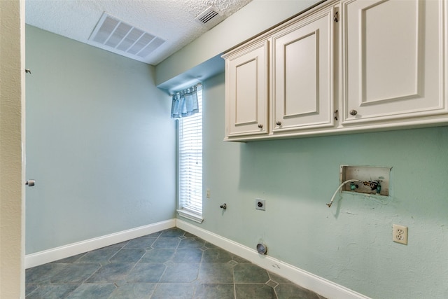 laundry area featuring cabinet space, hookup for an electric dryer, hookup for a washing machine, hookup for a gas dryer, and baseboards