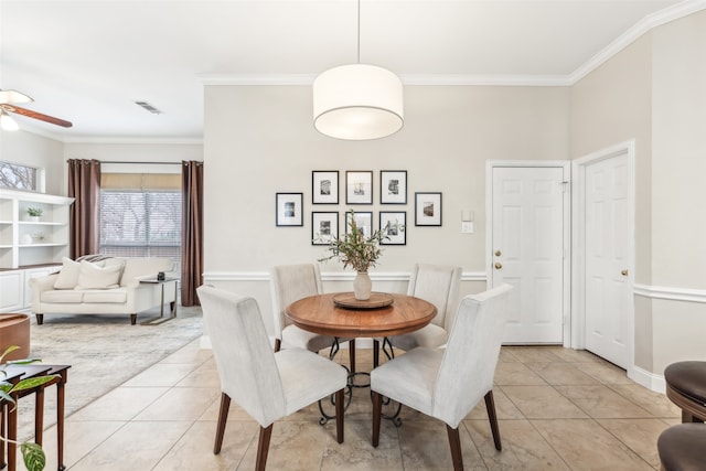 dining area featuring light tile patterned floors, visible vents, ornamental molding, and a ceiling fan