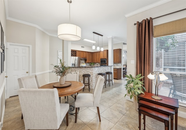 dining area with light tile patterned flooring and crown molding