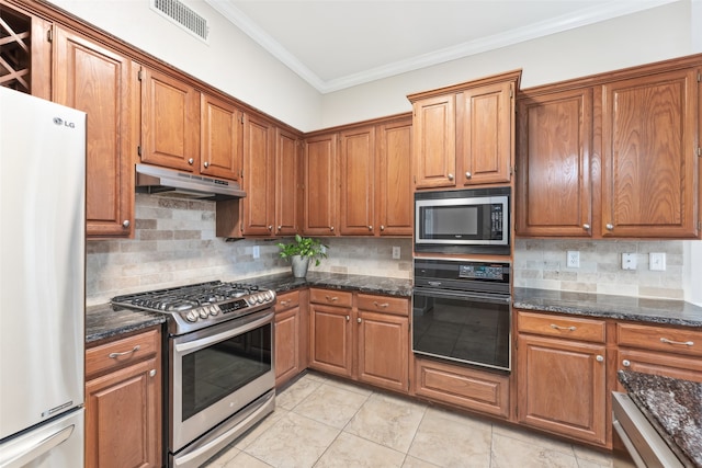 kitchen featuring visible vents, appliances with stainless steel finishes, brown cabinets, ornamental molding, and under cabinet range hood