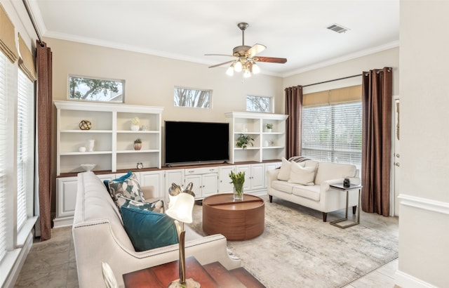 living room with ornamental molding, visible vents, and a ceiling fan