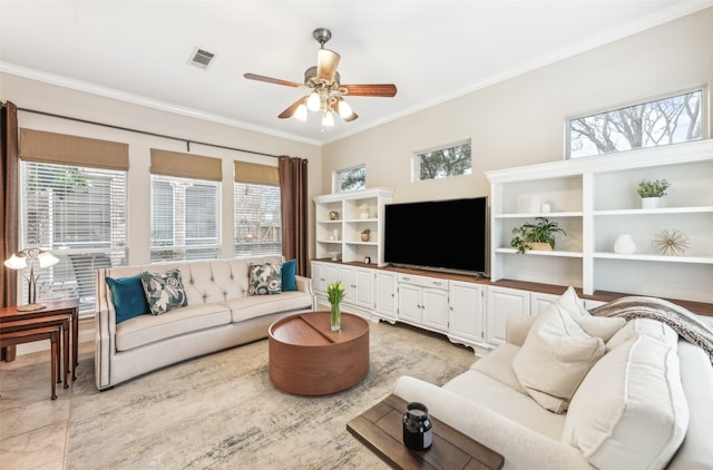 living room featuring a ceiling fan, visible vents, a wealth of natural light, and ornamental molding