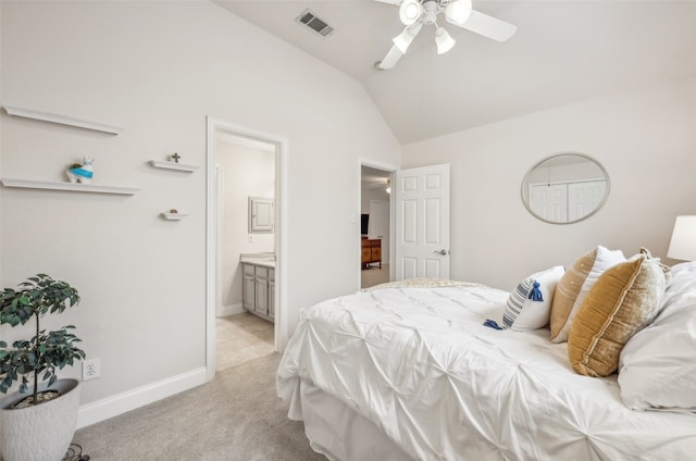 bedroom featuring baseboards, visible vents, connected bathroom, light colored carpet, and vaulted ceiling