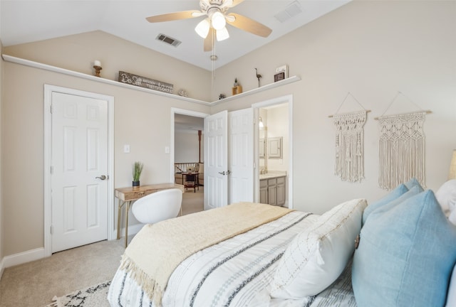 bedroom with lofted ceiling, light colored carpet, visible vents, and ensuite bath