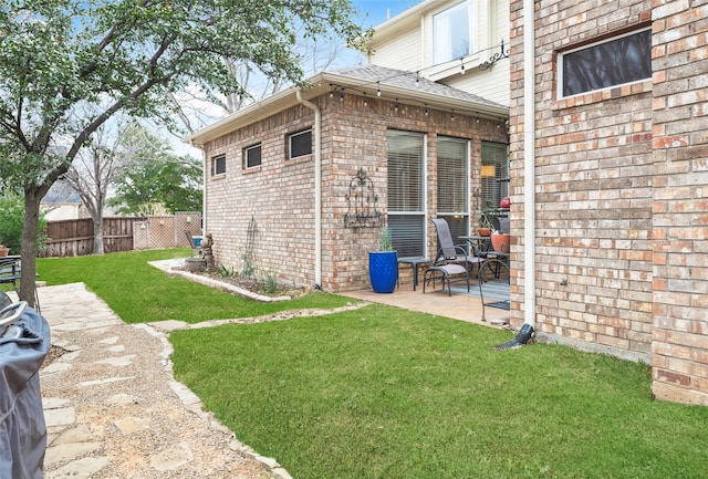 view of yard featuring fence and a patio