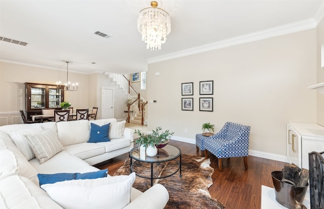 living area featuring stairs, visible vents, a notable chandelier, and ornamental molding