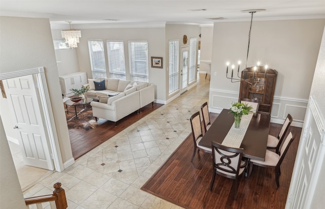 dining area with ornamental molding and a notable chandelier