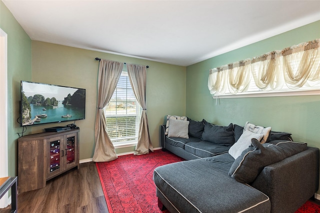 living area featuring baseboards and wood finished floors