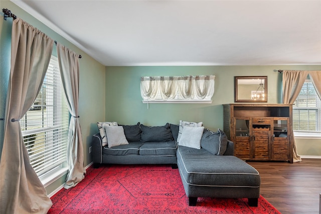 living area featuring baseboards and wood finished floors