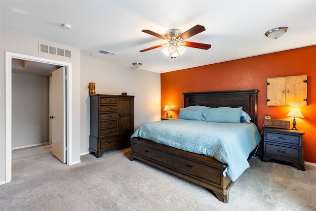 bedroom with light carpet, ceiling fan, and visible vents