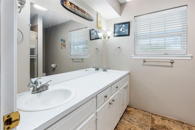 full bathroom with a shower, a sink, toilet, and double vanity