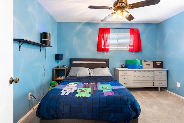 carpeted bedroom with ceiling fan and baseboards