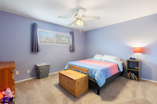 bedroom featuring light carpet, ceiling fan, and baseboards