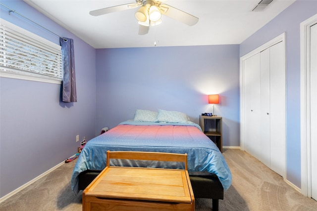 bedroom featuring light carpet, a closet, visible vents, and baseboards