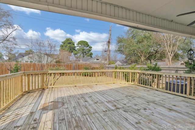 deck with a fenced backyard and central AC unit