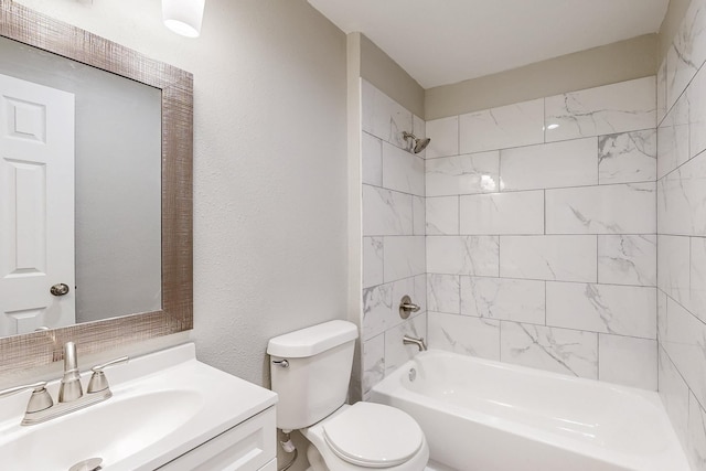 bathroom featuring a textured wall, shower / bathing tub combination, vanity, and toilet