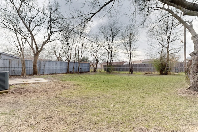 view of yard featuring a fenced backyard and central AC unit