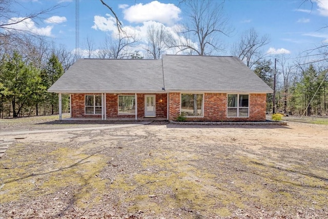 view of front of home featuring a porch and brick siding