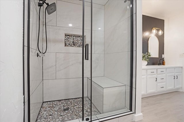 bathroom featuring a shower stall and vanity